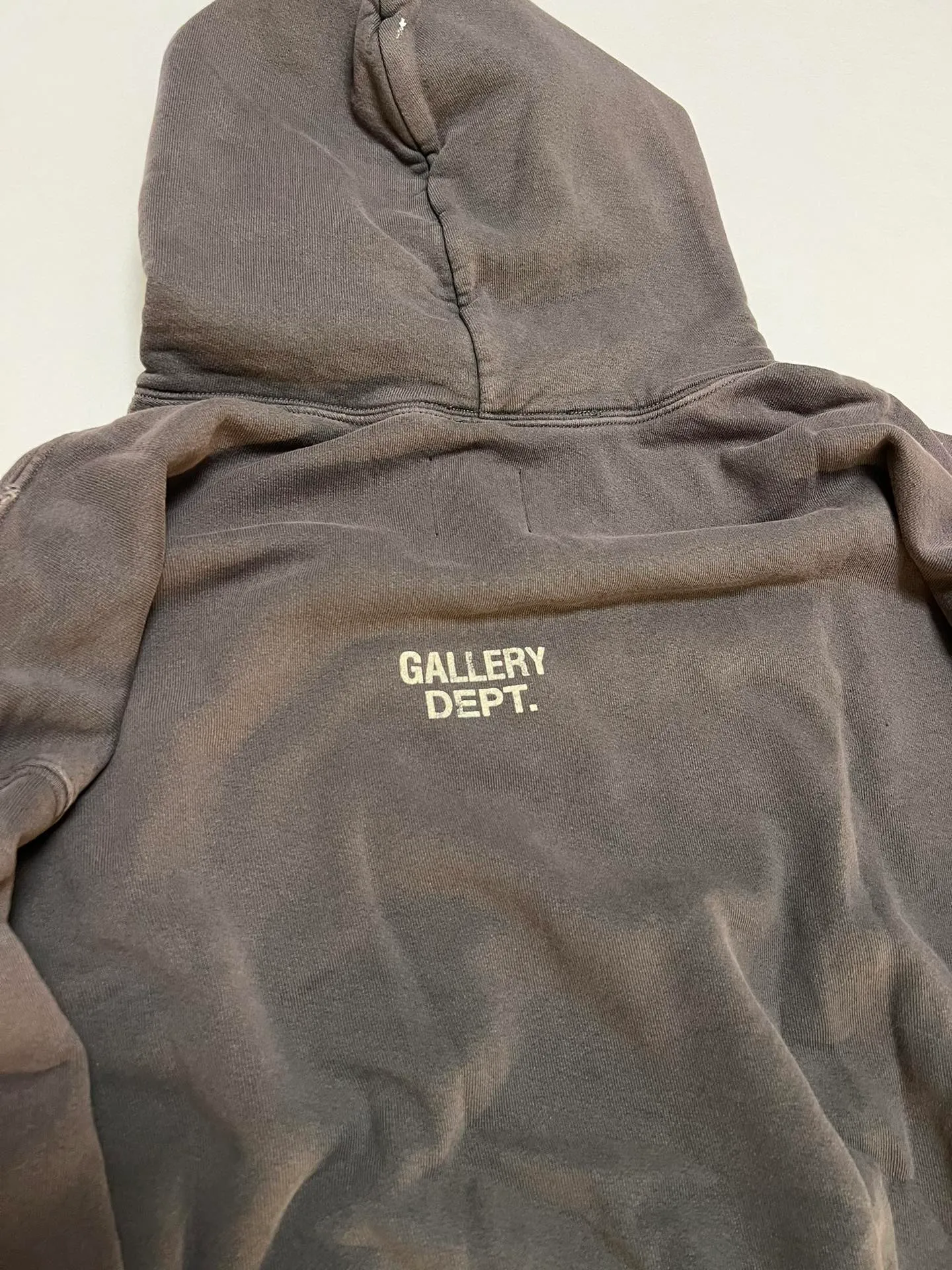 GALLERY DEPT. 90'S RECYCLE HOODIE WASHED BLACK 90'S washed hoodie with distressed eco-friendly slogans. Washed black S-XL. Ready-made garments are washed and dyed again. Multiple spots throughout the body are spray-faded. The ribs are cut and worn.